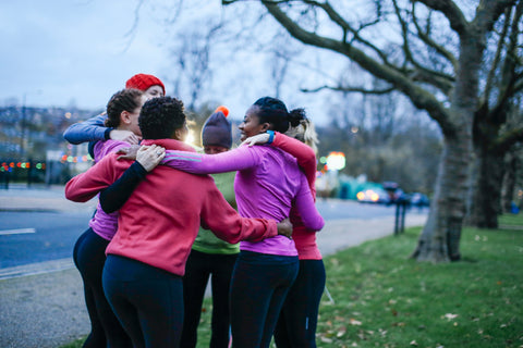 Group of women hugging one another in a circle